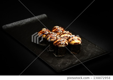 Delicious Fresh Salmon Sushi Rolls Presenting Exquisitely on a Black Background 138872958