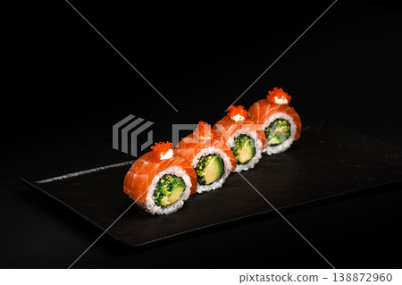 Delicious Fresh Sushi Rolls Presenting Exquisitely on a Black Background Delicious Fresh Sushi Rolls Presenting Exquisitely on a Black Background 138872960