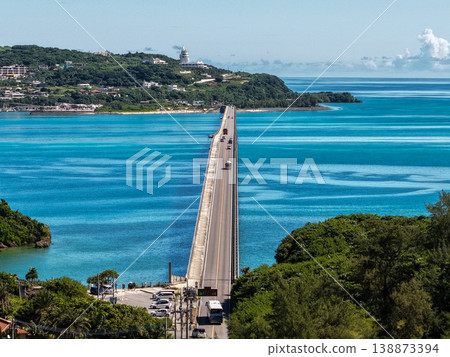 A vertical aerial photograph of the bridge leading to Kouri Island in Okinawa, taken directly above, against the backdrop of the emerald green sea. A vertical aerial photograph of the bridge leading to Kouri Island in Okinawa, taken directly above, against the backdrop of the emerald green sea. 138873394