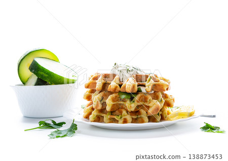 vegetable waffles with zucchini and creamy herb sauce on plate vegetable waffles with zucchini and creamy herb sauce on plate 138873453