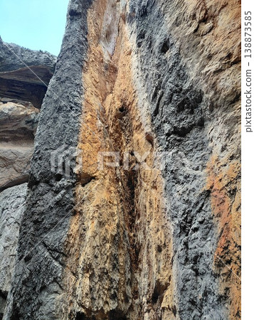 Rugged cave texture with layered rock formations and natural colors 138873585