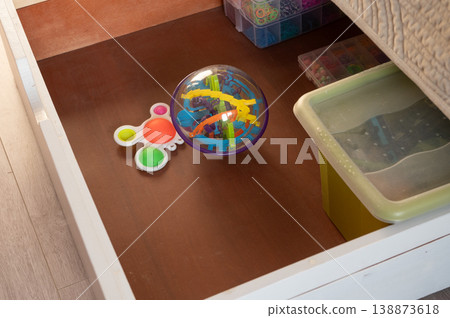 Puzzle sphere and pop it toy in organized toy drawer 138873618