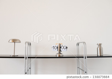 Black shelf displaying clock lamp and bottle in minimalist interior Black shelf displaying clock lamp and bottle in minimalist interior 138873664