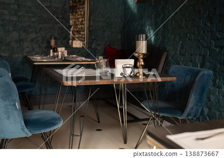 Restaurant table set with velvet chairs in intimate interior Restaurant table set with velvet chairs in intimate interior 138873667