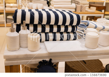 Striped towels stacked with soaps and dispensers on display Striped towels stacked with soaps and dispensers on display 138873690