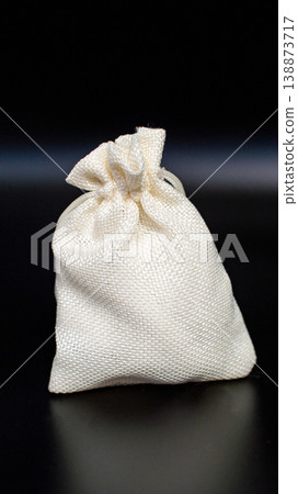 Small burlap sack against black background Small burlap sack against black background 138873717