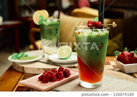 Frozen matcha in the glass with fresh raspberry juice, decorated with fresh natural raspberries. Standing on the wooden coffee table 138874180