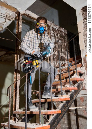 Safety officer evaluates deteriorated steps for potential hazards 138874414