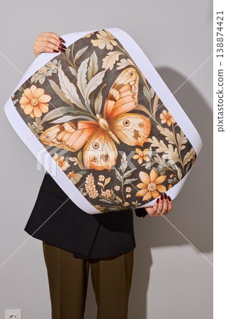 Woman adjusting outfit in studio with floral motif background Woman adjusting outfit in studio with floral motif background 138874421