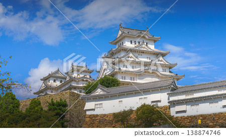 Himeji, Japan - Sep 24 2024, Panoramic view of Himeji Castle, White Heron Castle with trees and plants of park on foreground, at daytime with blue cloudy sky, without people, Himeji, Japan 138874746