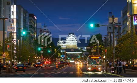 Himeji, Japan - Sep 24 2024, panoramic view of Himeji central street with White Heron Castle in background, at night with lights, cars driving along road, all traffic lights are green, Himeji, Japan Himeji, Japan - Sep 24 2024, panoramic view of Himeji central street with White Heron Castle in background, at night with lights, cars driving along road, all traffic lights are green, Himeji, Japan 138874749