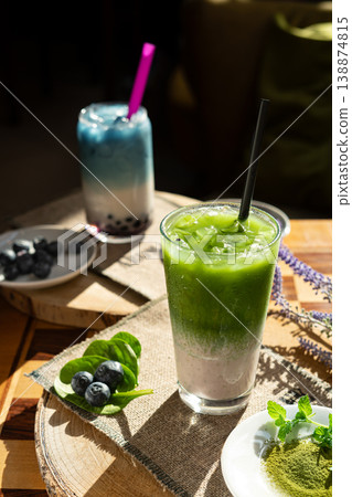 Frozen milkshake with matcha tea standing on a wooden table. 138874815