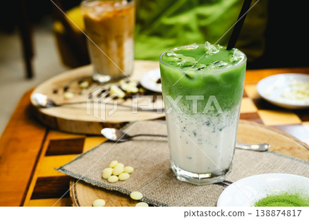 Frozen milkshake with matcha tea standing on a wooden table. Frozen milkshake with matcha tea standing on a wooden table. 138874817