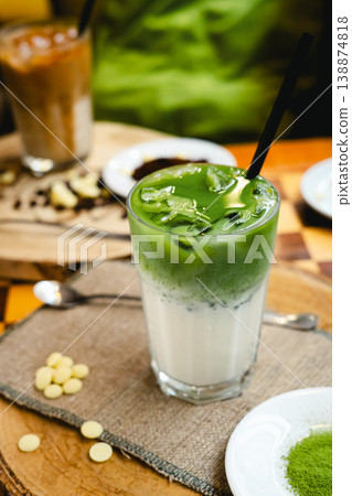 Frozen milkshake with matcha tea standing on a wooden table. Frozen milkshake with matcha tea standing on a wooden table. 138874818