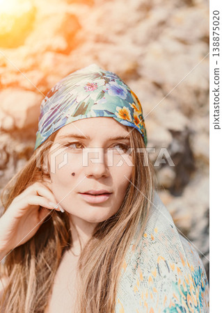 Woman bandana portrait posing in natural sunlight wearing floral headscarf for summer fashion Woman bandana portrait posing in natural sunlight wearing floral headscarf for summer fashion 138875020