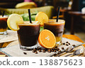 A glass of Espresso Sunrise on a coffee table, decorated with slice of orange. Refreshing and energizing drinks for a hot summer day, natural light, minimal composition, vibrant lifestyle scene. 138875623