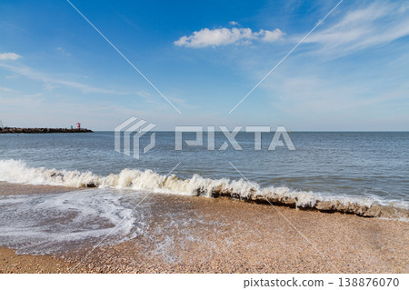 Sea waves on sandy beach in The Hague Netherlands Sea waves on sandy beach in The Hague Netherlands 138876070