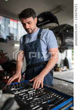 Mechanic searching for the right tool in his toolbox 138876251
