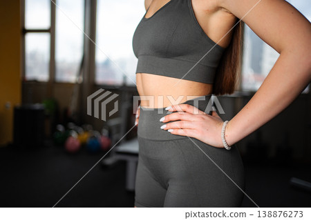 Woman exercising in gym, preparing for fitness workout 138876273