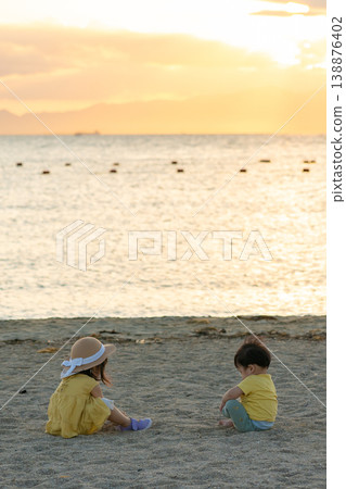 Toddler playing on the sandy beach Toddler playing on the sandy beach 138876402