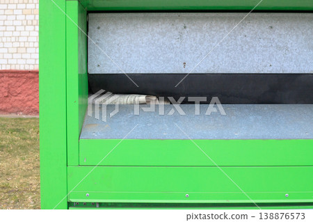 Trash container for collecting street paper waste close-up. Waste recycling and an eco-friendly approach in the urban environment. 138876573
