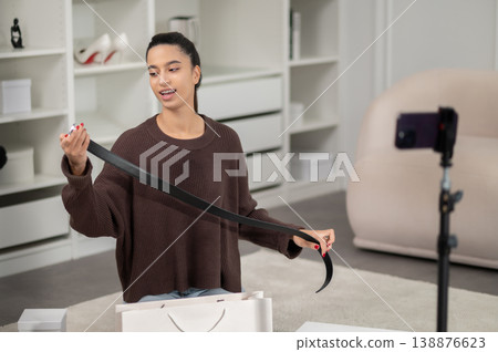 Fashion vlogger showing new fashionable stuff to her subscribers in social media 138876623