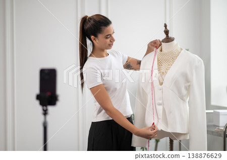Modern fashion designer presenting new clothes collection during live translation Modern fashion designer presenting new clothes collection during live translation 138876629
