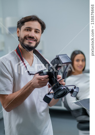 Male doctor checking photo results and looking contented Male doctor checking photo results and looking contented 138876668
