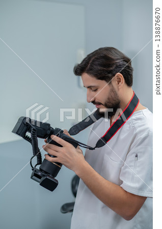 Male doctor checking photo results and looking contented 138876670