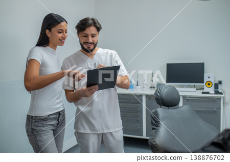 Long-haired young woman at the appointment in the dental clinic Long-haired young woman at the appointment in the dental clinic 138876702