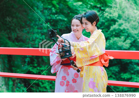 A woman in a yukata takes a selfie during a hot spring trip. 138876990