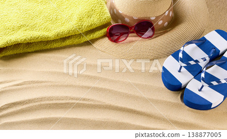 Summer concept with straw beach hat and sunglass,stylish flip-flops on a beach sand, top view. Summer concept with straw beach hat and sunglass,stylish flip-flops on a beach sand, top view. 138877005