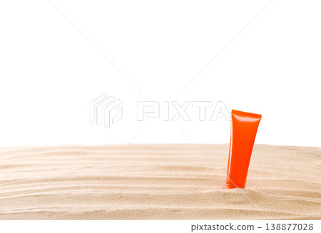 Bottle of sunscreen cream on sand beach isolated on a white background. Bottle of sunscreen cream on sand beach isolated on a white background. 138877028