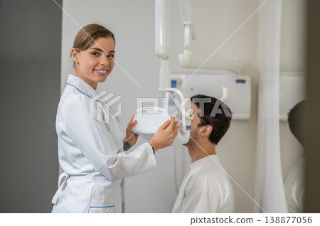 Female doctor looking at camera near dental equipment Female doctor looking at camera near dental equipment 138877056