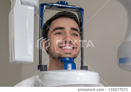 Close up of man during dental panoramic radiography Close up of man during dental panoramic radiography 138877072