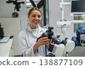 Female dentist holding professional photo camera 138877109