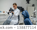 Female dentist holding professional camera with flash 138877114