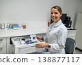 Female dentist sitting near open drawer with supplies 138877117
