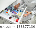 Female assistant opening drawer with supplies 138877130