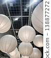 Hanging white lanterns in a modern indoor space during evening hours 138877272