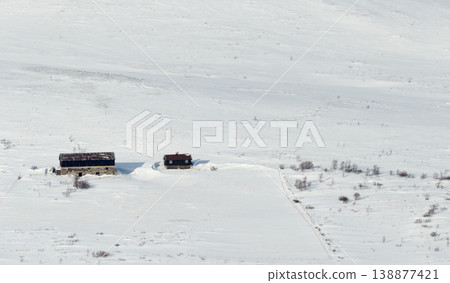 Small traditional cabins in a snowy Norwegian mountain landscape 138877421