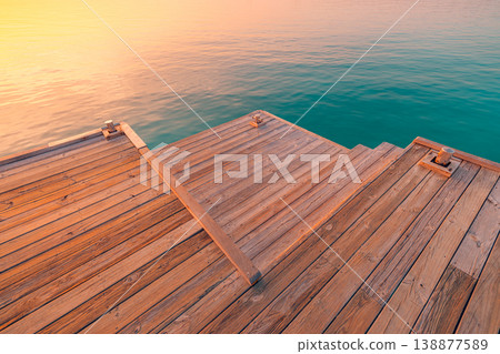 Stunning ocean bay sunset calm water surface wooden deck pier edge abstract sea background summer inspiring travel scenic landscape wallpaper 138877589