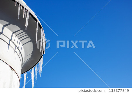 Frozen urban scene. Minimalist shot of icy structure with sharp shadows and frozen droplets Frozen urban scene. Minimalist shot of icy structure with sharp shadows and frozen droplets 138877849