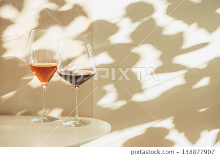Rose and Red Wine Glasses under Sunlight. Elegant Spring Still Life Rose and Red Wine Glasses under Sunlight. Elegant Spring Still Life 138877907