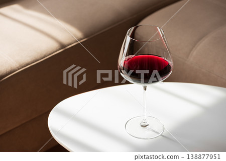 Red Wine Glass on White Table in Cozy Living Room Red Wine Glass on White Table in Cozy Living Room 138877951