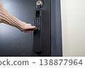 A woman opens a modern smart door lock with a digital keypad and biometric fingerprint access. 138877964