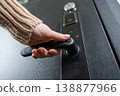 A woman opens a modern smart door lock with a digital keypad and biometric fingerprint access. 138877966