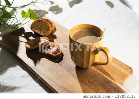 Cup of coffee with milk and toast with jam on wooden board. Breakfast Toast with Coffee. Cup of coffee with milk and toast with jam on wooden board. Breakfast Toast with Coffee. 138878113