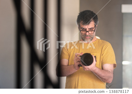 Male photographer with a professional camera taking a self-portrait in front of the mirror at home. Male photographer with a professional camera taking a self-portrait in front of the mirror at home. 138878117
