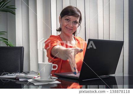 Smiling and happy business woman working with her mobile phone and laptop in the office. Smiling and happy business woman working with her mobile phone and laptop in the office. 138878118
